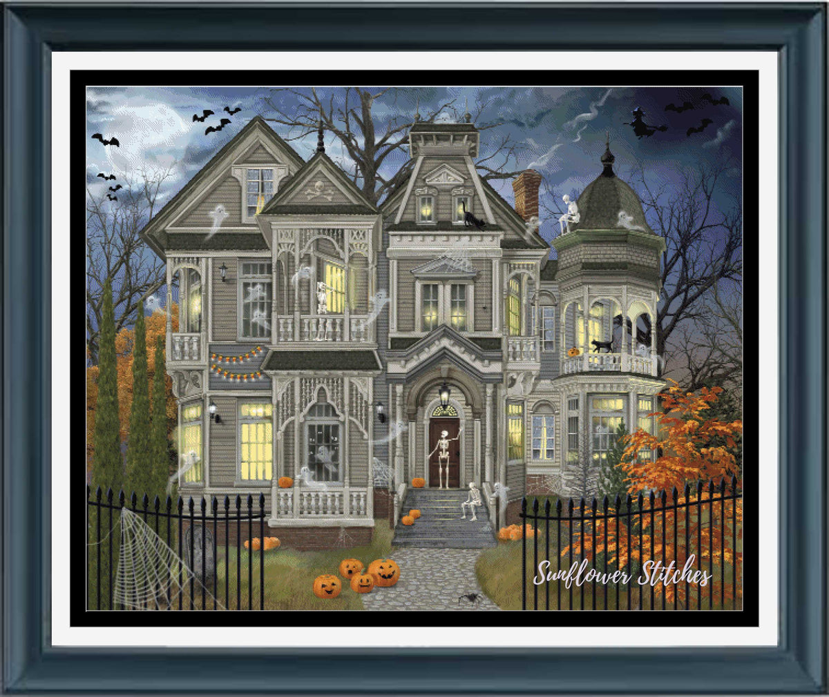 A framed Halloween-themed needlework or art print featuring a haunted Victorian house at night, with pumpkins, bats, ghosts, and the text 'Sunflower Stitches' in the lower right corner.