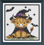 A framed cross-stitch or needlework design featuring a cute yellow-orange fluffy animal wearing a black witch hat and cape, with bats, stars, and a small pumpkin on a white stitched background 
