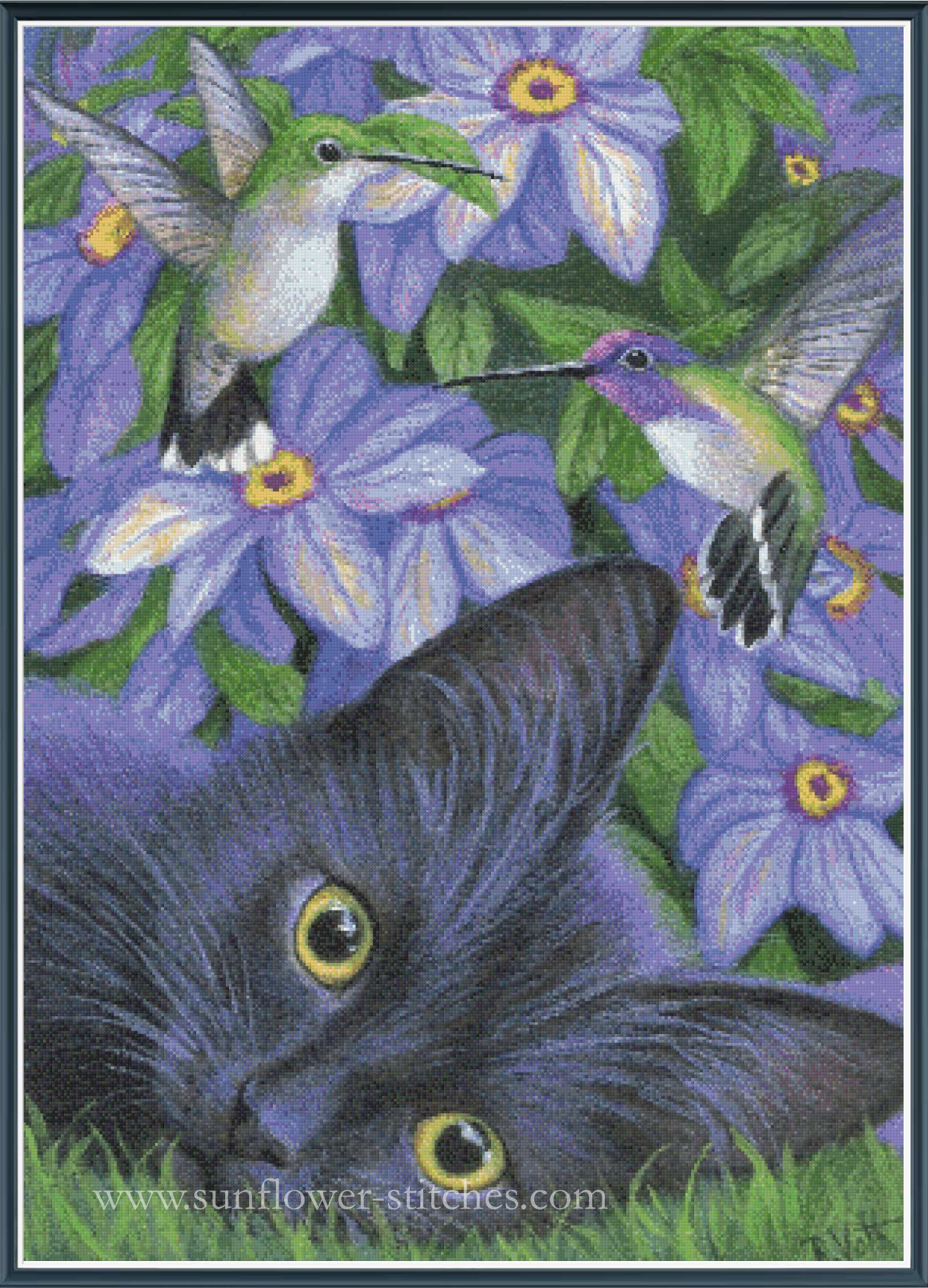 Cat lying on grass with hummingbirds and purple flowers in the background