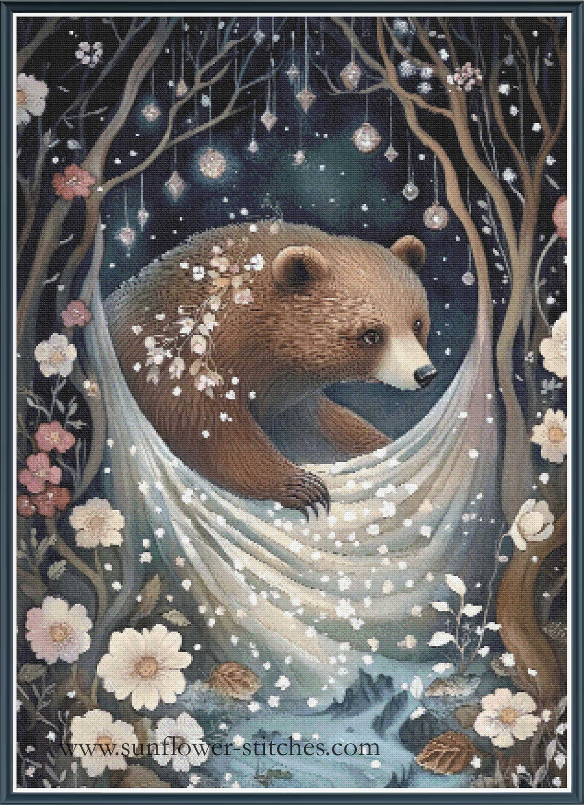 A whimsical fantasy cross stitch of a brown bear resting inside a large white hammock suspended between dark trees, with flowers, hanging ornaments, and a snowy forest scene around it.