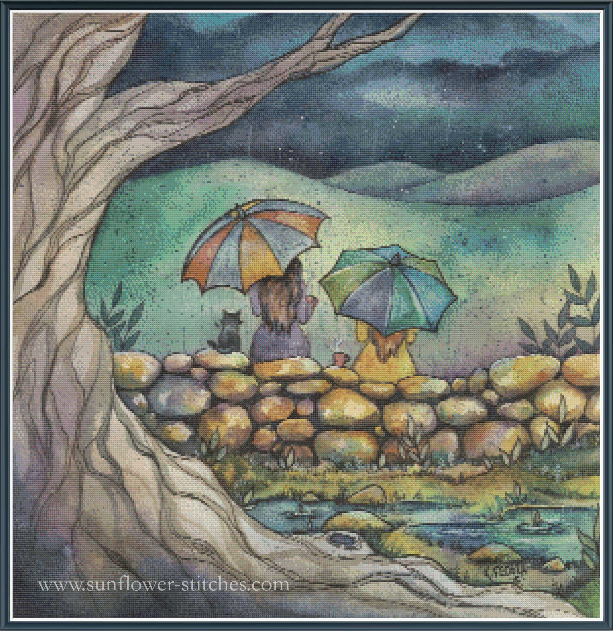 A square cross stitch featuring a whimsical outdoor scene with two figures under colorful umbrellas beside a stone wall and small pond, framed by a large tree trunk. The artwork has a dark blue border and the text 'www.