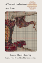 A Touch of Enchantment colour chart close-up showing cross-stitch symbols over the fairy’s flowing red hair, bodice and dress.
