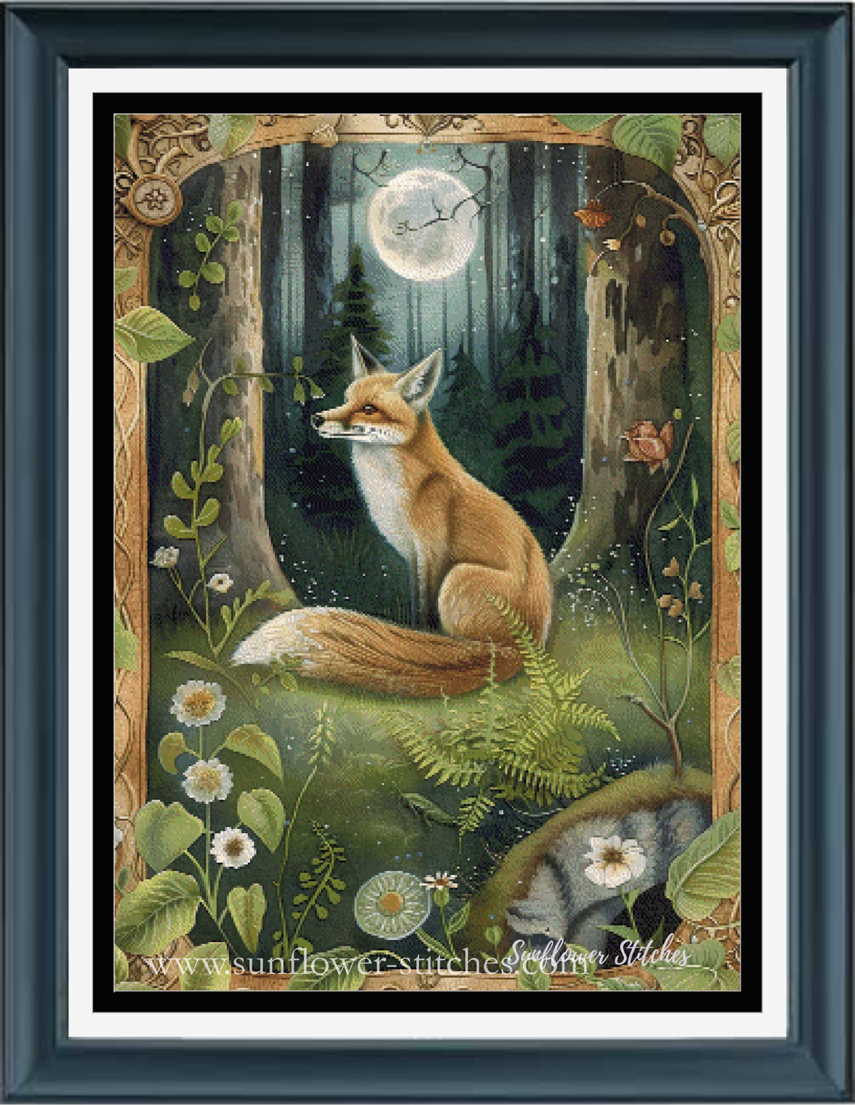 A framed cross stitch featuring a fox sitting in a moonlit forest, surrounded by flowers and foliage, with an ornate decorative border. The print is presented in a dark blue frame with a white mat.